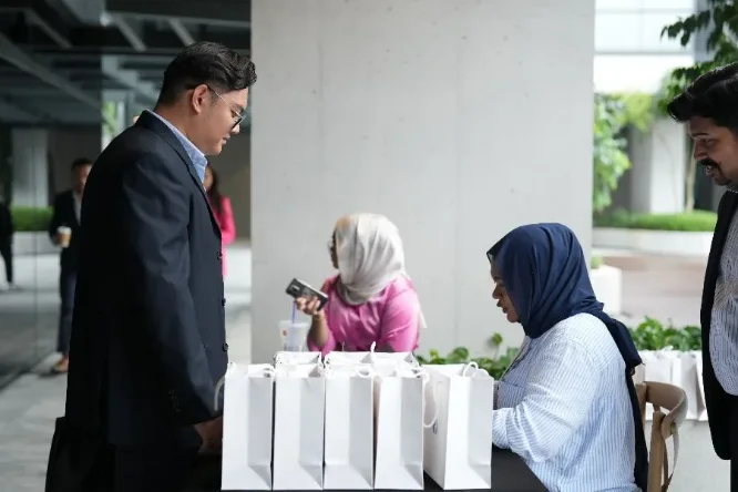 Guests collecting welcome bags at the registration desk