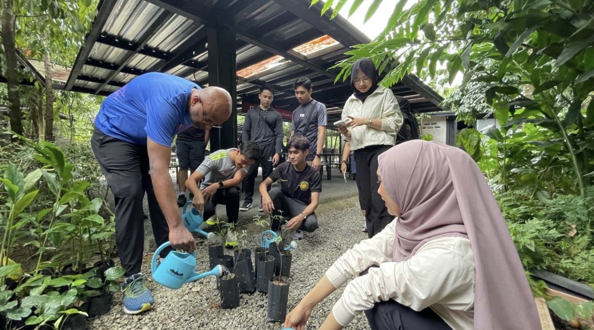 Free Tree Society volunteers watering saplings with the Telcowin team