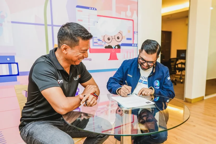 Telcowin and WithU Yamaha RNF representatives shaking hands