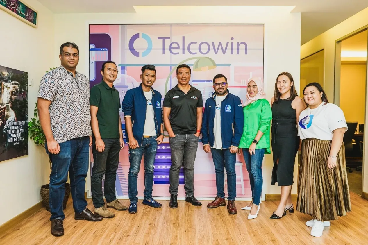 Telcowin team discussing the partnership in the office