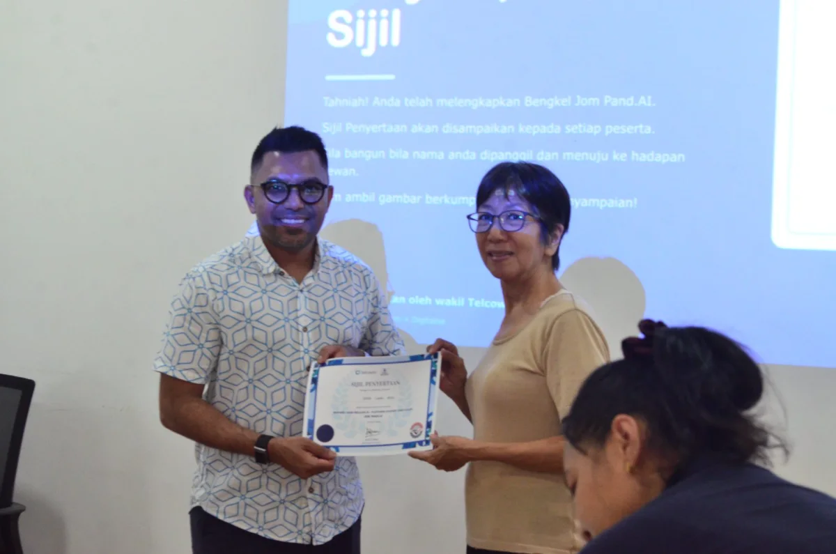 A participant receiving their certificate of completion