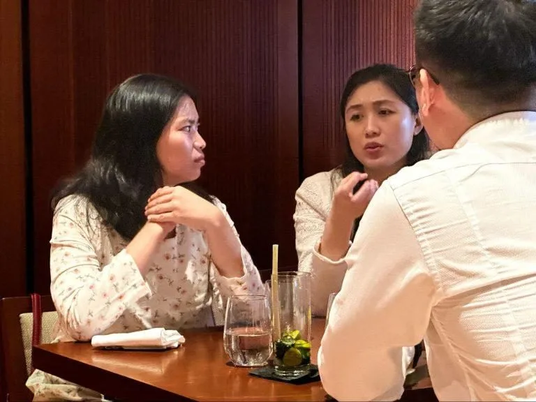 Guests in conversation over dinner